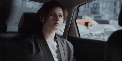 woman riding in a taxi service in taupo and talking on the phone using bluetooth headset